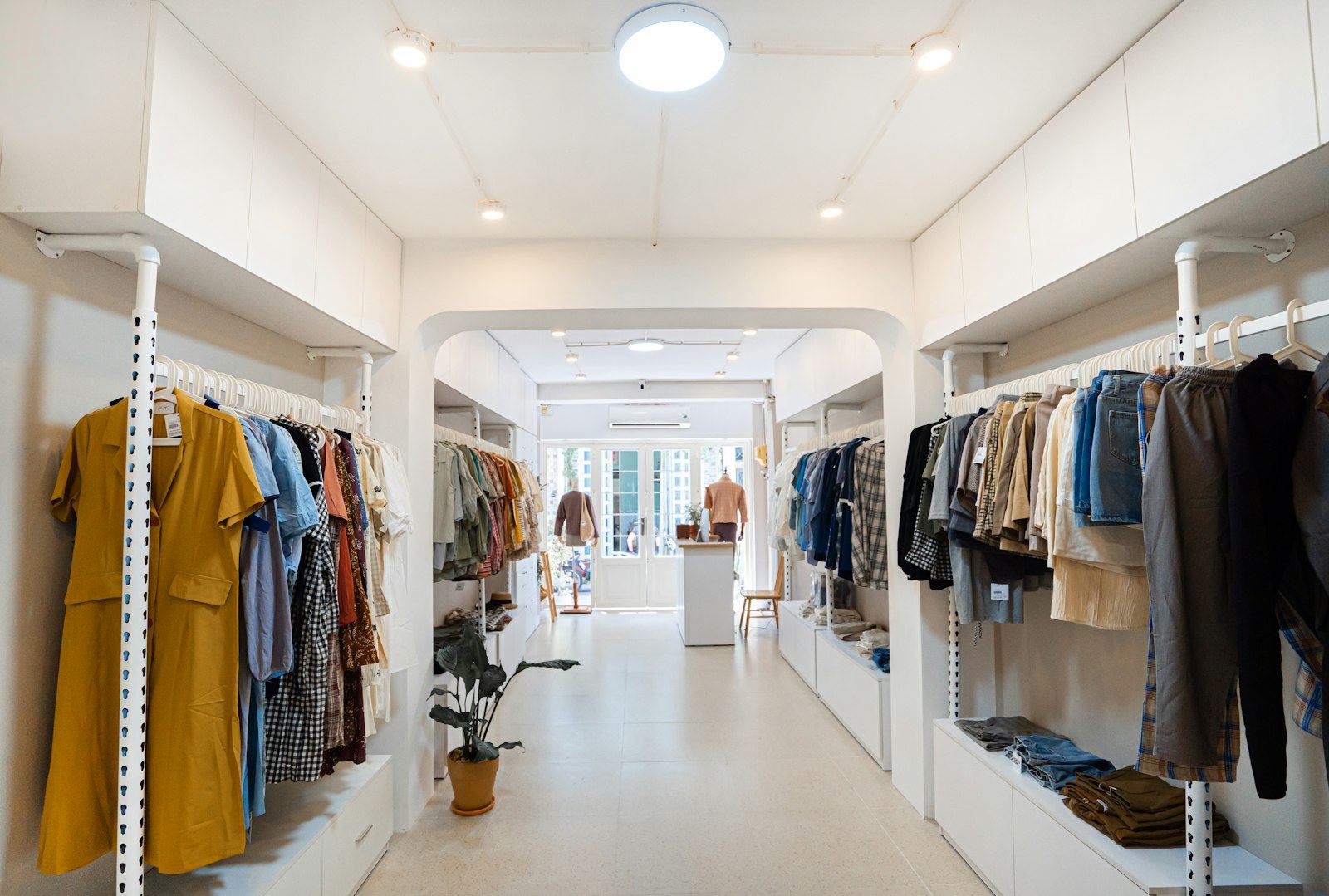 Clothes on rails in a bright, airy boutique